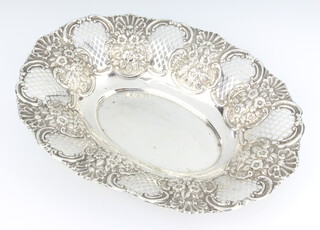 An Edwardian pierced and repousse silver oval dish decorated with flowers, Chester 1903, 32cm, 314 grams