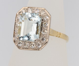 An 18ct yellow gold aquamarine and diamond ring, the centre stone 3.1ct surrounded by brilliant cut diamonds 0.6ct, size O 