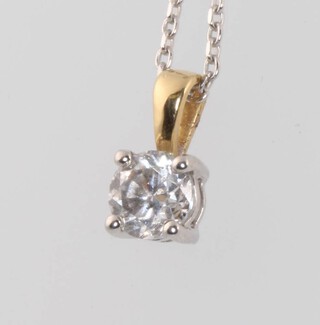 An 18ct yellow gold single stone diamond pendant, approx 0.5ct on an 18ct white gold 40cm chain 