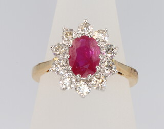 An 18ct yellow gold oval ruby and diamond ring, the centre stone 1.5ct the diamonds approx. 1ct, size N 
