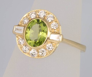 An 18ct yellow gold peridot and diamond cluster ring, the centre stone 1.3ct surrounded by brilliant cut diamonds 0.5ct, size N