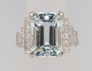 An Art Deco style platinum aquamarine and diamond ring, the centre stone approx. 9ct flanked by brilliant cut diamonds 0.48ct, size P 