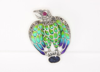 A silver eagle brooch set with enamels, marcasite, rubies and sapphires