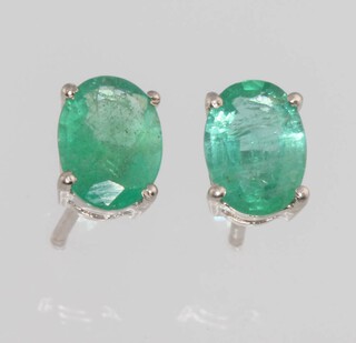 A pair of silver and emerald ear studs 
