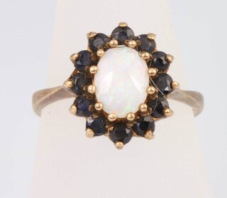 A 9ct yellow gold opal and garnet cluster ring, size N, 3.3 grams