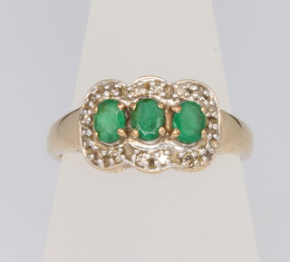 A 9ct yellow gold emerald and diamond triple cluster ring size O 1/2, 3.5 grams 