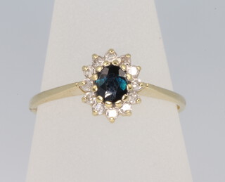 An 18ct yellow gold sapphire and diamond cluster ring size N