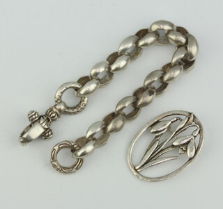 A silver bracelet and brooch, 111 grams
