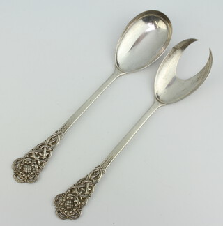 A pair of silver salad servers with fancy handles London 1957, 218 grams 