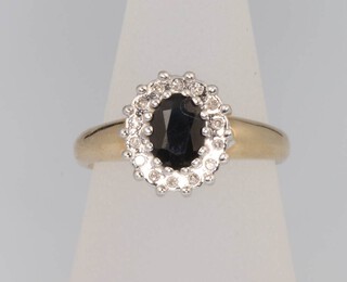 A 14ct oval sapphire and diamond cluster ring, the centre stone 0.75ct, size M, 4.1 grams