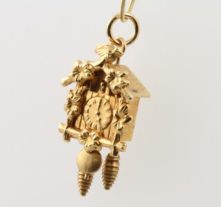A 14ct yellow gold cuckoo clock pendant and chain, 4.1 grams 