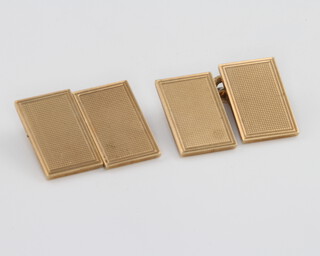 A pair of 9ct yellow gold engine turned rectangular cufflinks 10.9 grams