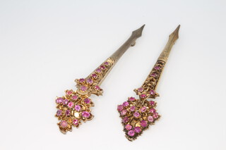 A near pair of Indian silver gilt gem set pins 10cm 
