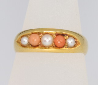 An 18ct yellow gold coral and pearl ring size N 1/2, 3.2 grams 