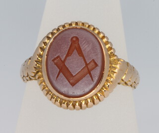 A 15ct yellow gold carved Masonic agate ring size Q, 5.5 grams