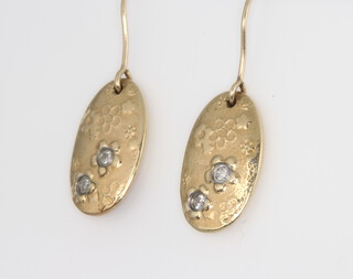 A pair of 9ct yellow gold diamond set oval earrings, 3 grams