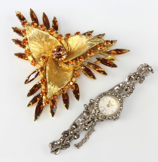 A lady's Accurist silver and marcasite watch and a spray brooch