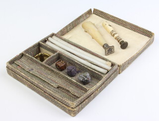 A carved mother of pearl and silver desk seal, a bone ditto in a fitted box 