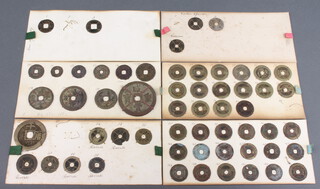 A quantity of Chinese bronze coins including Ming Dynasty attached to 5 cards