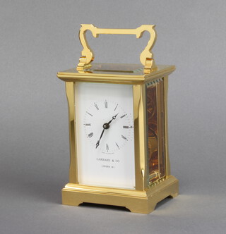 Garrards and Company, a 20th Century carriage timepiece with enamelled dial and Roman numerals contained in a gilt metal case, complete with key and original box 