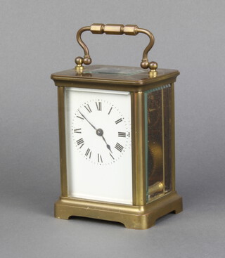 A 19th Century French carriage timepiece with enamelled dial and Roman numerals contained in a gilt metal case, complete with key 