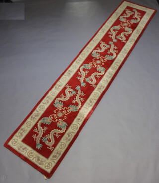 A red and cream ground Chinese runner decorated dragons 371cm x 76cm 