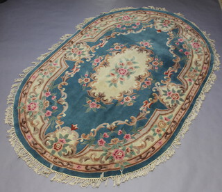 An oval blue and floral patterned Indian carpet 267cm x 178cm  