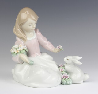 A Lladro figure of a seated girl with a rabbit 6931 14cm 