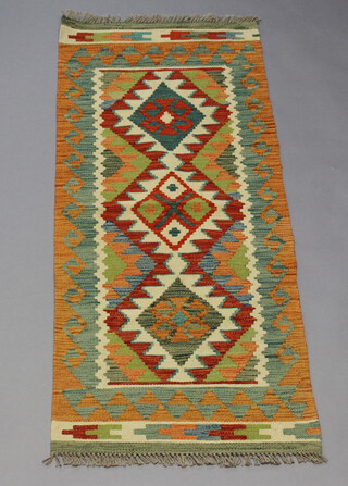 A white, green and turquoise Chobi Kilim runner with 3 diamonds to the centre 146cm x 60cm 