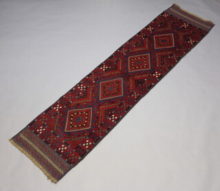 A red and blue ground Meshwani runner with 4 diamonds to the centre 265cm x 65cm 