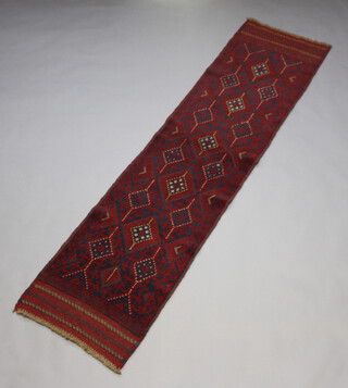 A red and blue ground Meshwani runner with 16 diamonds to the centre 248cm x 60cm 
