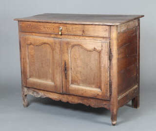 An 18th Century Continental oak cabinet fitted a drawer above a cupboard, raised on shaped supports 99cm h x 124cm x 59cm d 