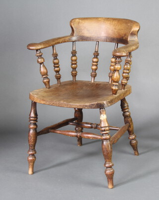 An elm smokers bow chair, raised on turned supports with double H framed stretcher 