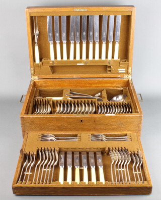 A part canteen of Mappin and Webb Old English rat tail pattern silver plated flatware in an oak box and a pair of silver plated fish servers 
