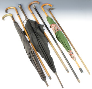 An ebony walking cane with silver terminal, walking stick with 9ct gold band, 2 canes with silver handle and 3 umbrellas