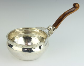 A Continental planished sterling silver brandy saucepan with carved wooden handle, base marked 925, 256 grams