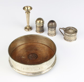 A cylindrical pierced silver 3 piece condiment set comprising salt, pepper and mustard pot, Birmingham 1926,a waisted silver specimen vase Birmingham 1964 8cm h and a silver bottle coaster London 1986, weighable silver 38 grams 