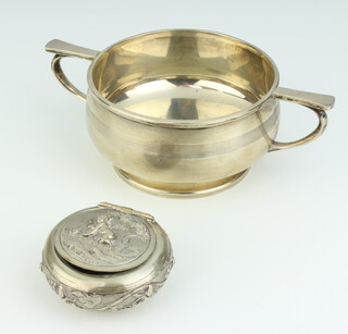 A silver twin handled porringer Birmingham 1947 184 grams, together with an Eastern white metal tobacco box and cover 5cm diam. 