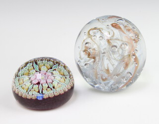 A circular glass and cane paperweight signed P 5cm, together with a bubble glass ditto 7cm 