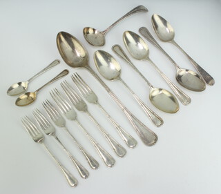 A 14 piece canteen of silver flatware comprising basting spoon, sauce ladle, 4 table spoons, 3 table forks, 3 pudding forks, 2 tea spoons, Sheffield 1923 together with a Georgian old English silver table spoon, 1191 grams 