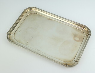 A rectangular silver dressing table tray with bracketed border, marks rubbed, 414 grams 