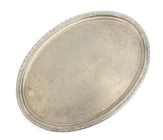A Continental oval silver salver with decorative border 35cm x 25cm, engraved, 741 grams 