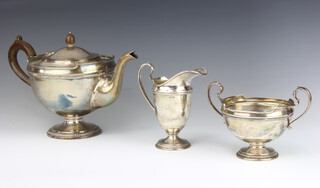 A silver 3 piece tea set with beaded decoration and fancy scroll handles, Sheffield 1922 and 1924, gross 1485 grams 