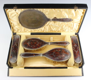 A silver and tortoiseshell plique a jour dressing table set comprising 2 hair brushes, 2 clothes brushes and a hand mirror 