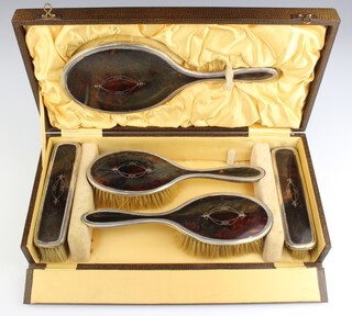 A silver and tortoiseshell plique a jour dressing table set comprising two hair brushes, 2 clothes brushes and a hand mirror, Birmingham 1949, boxed 