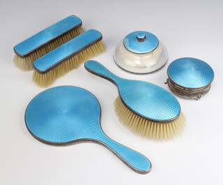 A silver and blue guilloche enamelled dressing table set comprising hair brush, 2 clothes brushes, hand mirror, trinket box and powder jar, Birmingham 1930 and 1932