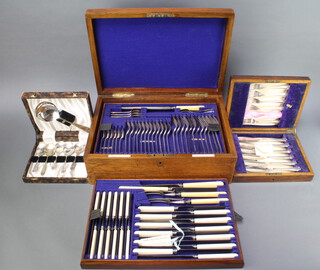 An Edwardian mahogany canteen containing a quantity of plated cutlery and 2 cased plated sets