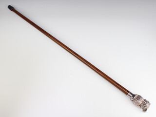 A hardwood walking cane with a silver filled owl grip 