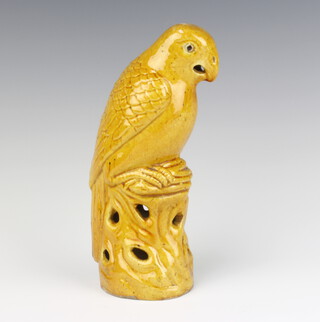 A Chinese yellow glazed figure of a cockatoo 21cm, Chinese painted glass snuff bottle with floral decoration and bird on branch, base with seal mark 7cm, a Chinese gilt metal and hardstone mounted pipe 8cm  