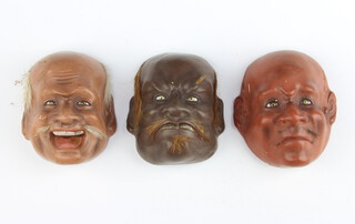 Three Japanese miniature lacquered face masks 5cm x 4cm 
